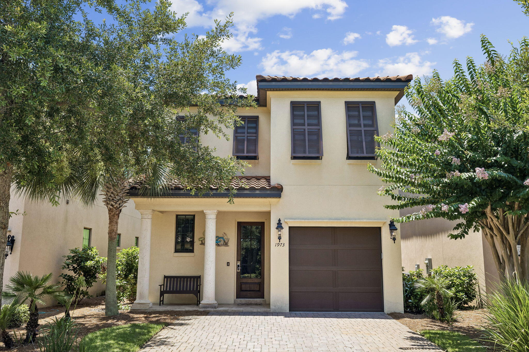 1973 Baytowne Loop Miramar Beach, FL 32550 - Photo 3 of 38 a front view of a house with plants and trees