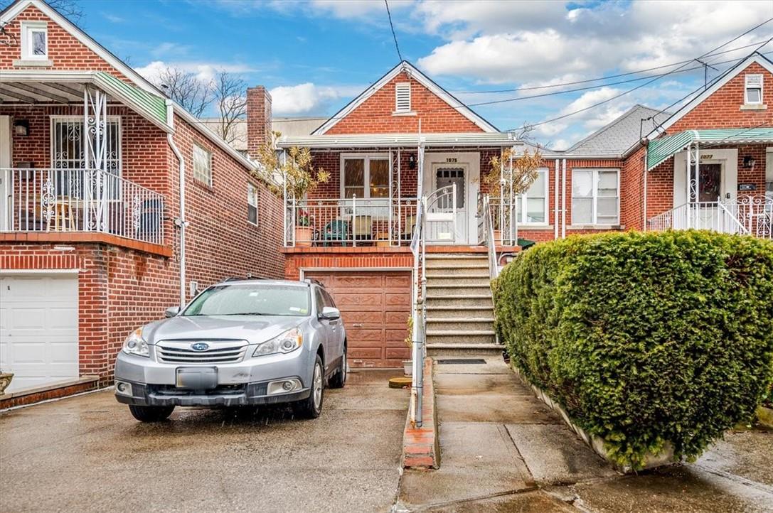 a car parked in front of a brick house