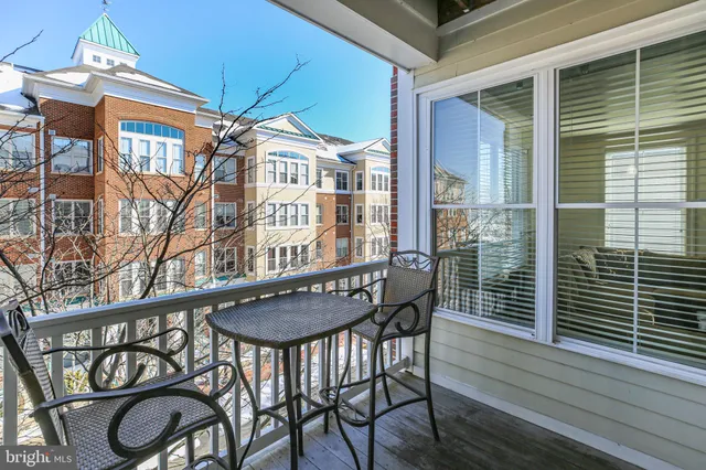 a balcony with table and chairs