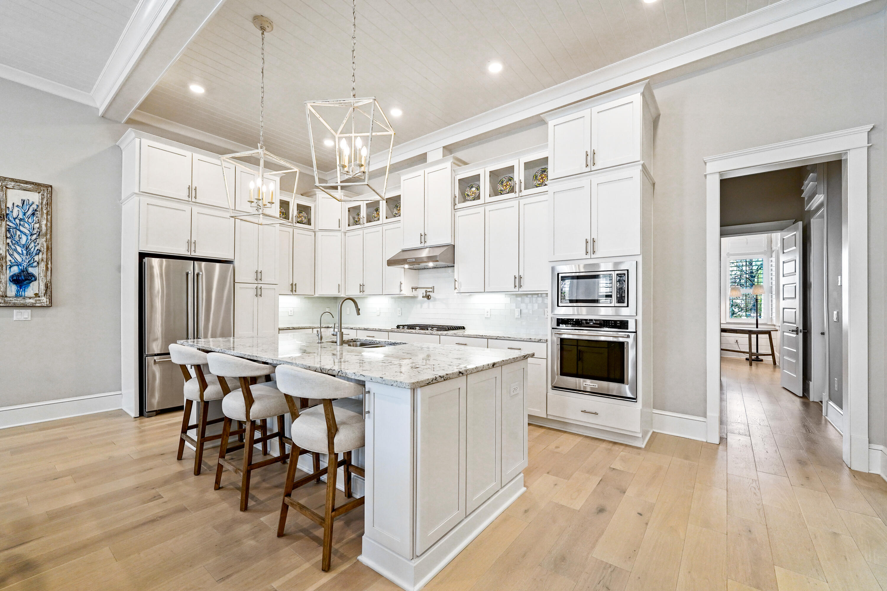 82 Siasconset Ln Inlet Beach Inlet Beach, FL 32461 - Photo 7 of 42 a kitchen with stainless steel appliances a dining table chairs stove and white cabinets