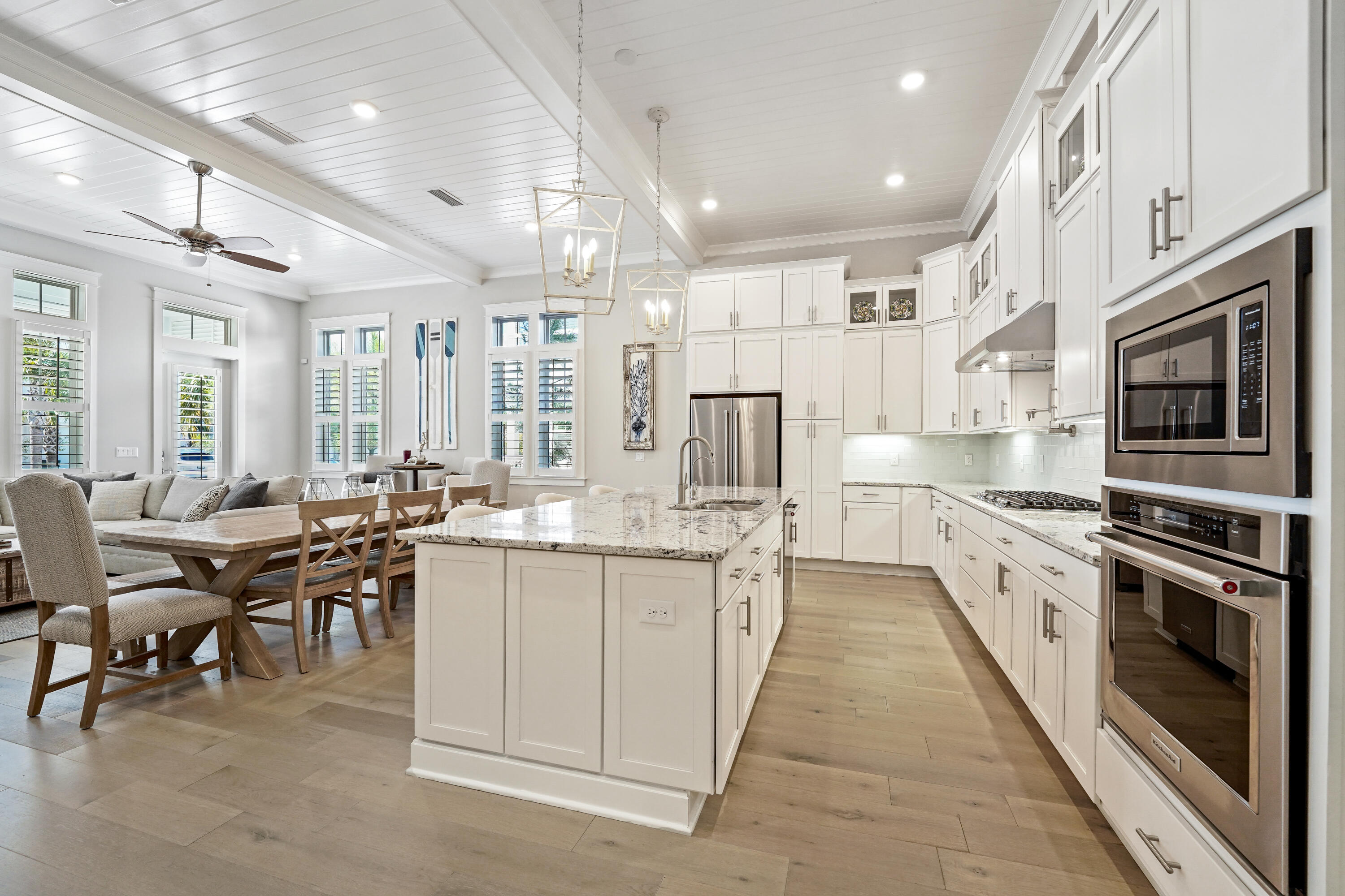 82 Siasconset Ln Inlet Beach Inlet Beach, FL 32461 - Photo 8 of 42 a large kitchen with stainless steel appliances lots of white cabinets a dining table and chairs