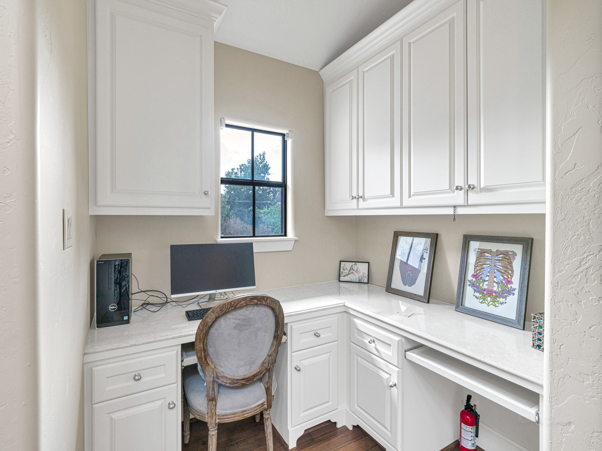 4614 Inker Street Houston, TX 77007 - Photo 28 of 36 A home office nook or kids’ homework space with white cabinetry, ample counter space, and natural light.