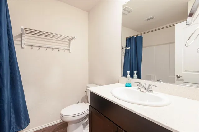 a bathroom with a sink toilet and a mirror