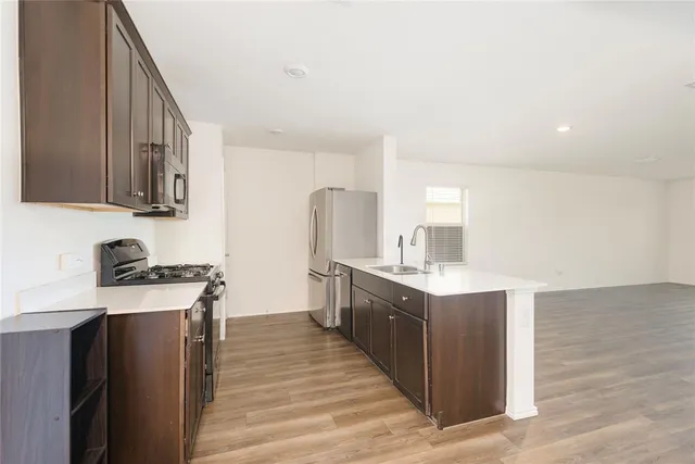 a kitchen with a stove top oven sink and cabinets