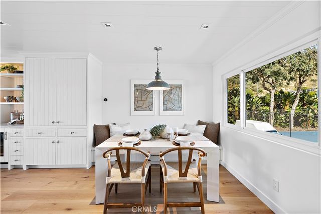a dining room with furniture a chandelier and wooden floor