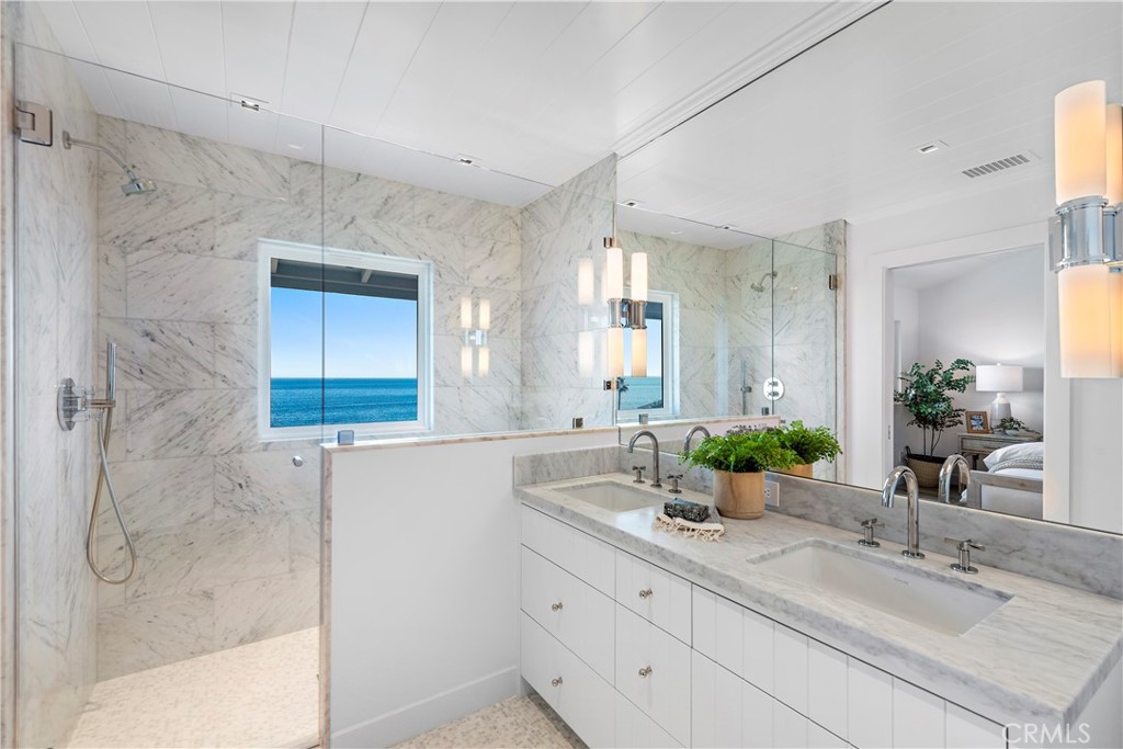25 Blue Lagoon Laguna Beach, CA 92651 - Photo 29 of 53 a bathroom with a granite countertop sink mirror and shower