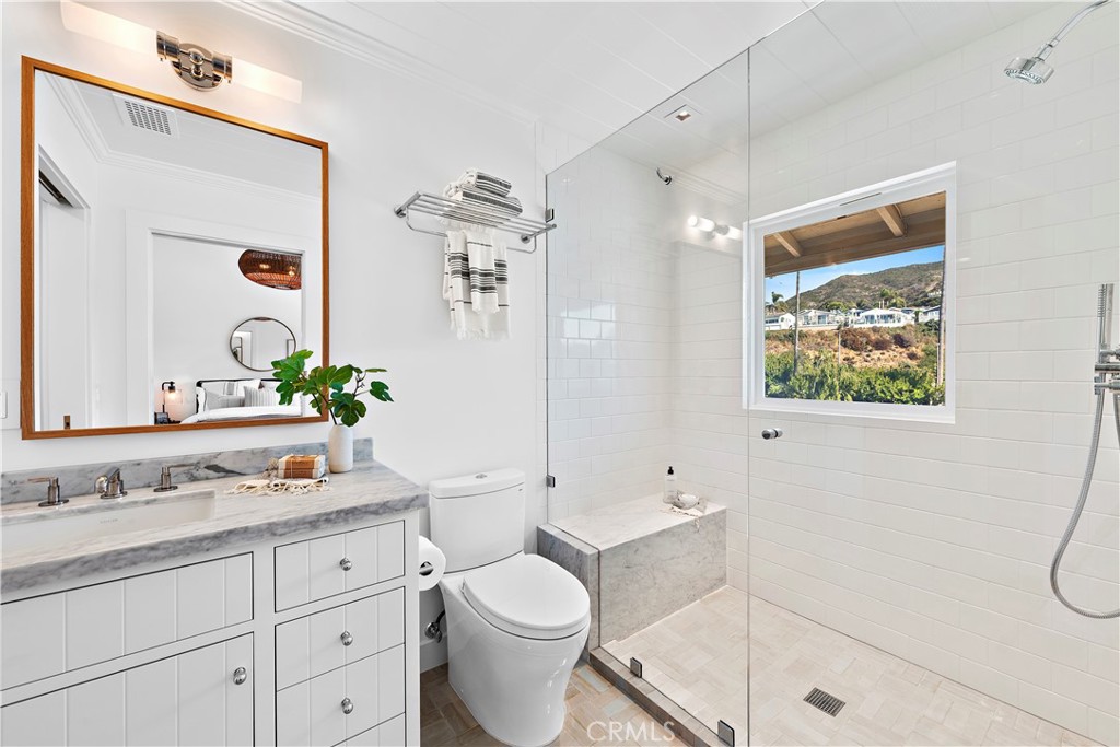 25 Blue Lagoon Laguna Beach, CA 92651 - Photo 35 of 53 a bathroom with a granite countertop sink mirror vanity and toilet