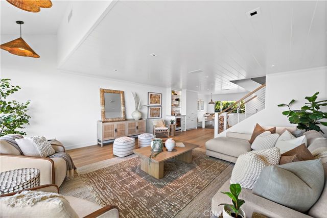 a living room with furniture and potted plant