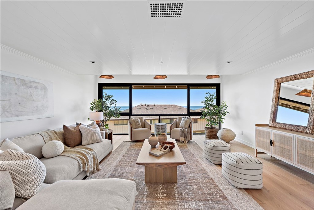25 Blue Lagoon Laguna Beach, CA 92651 - Photo 8 of 53 a living room with furniture and a large window
