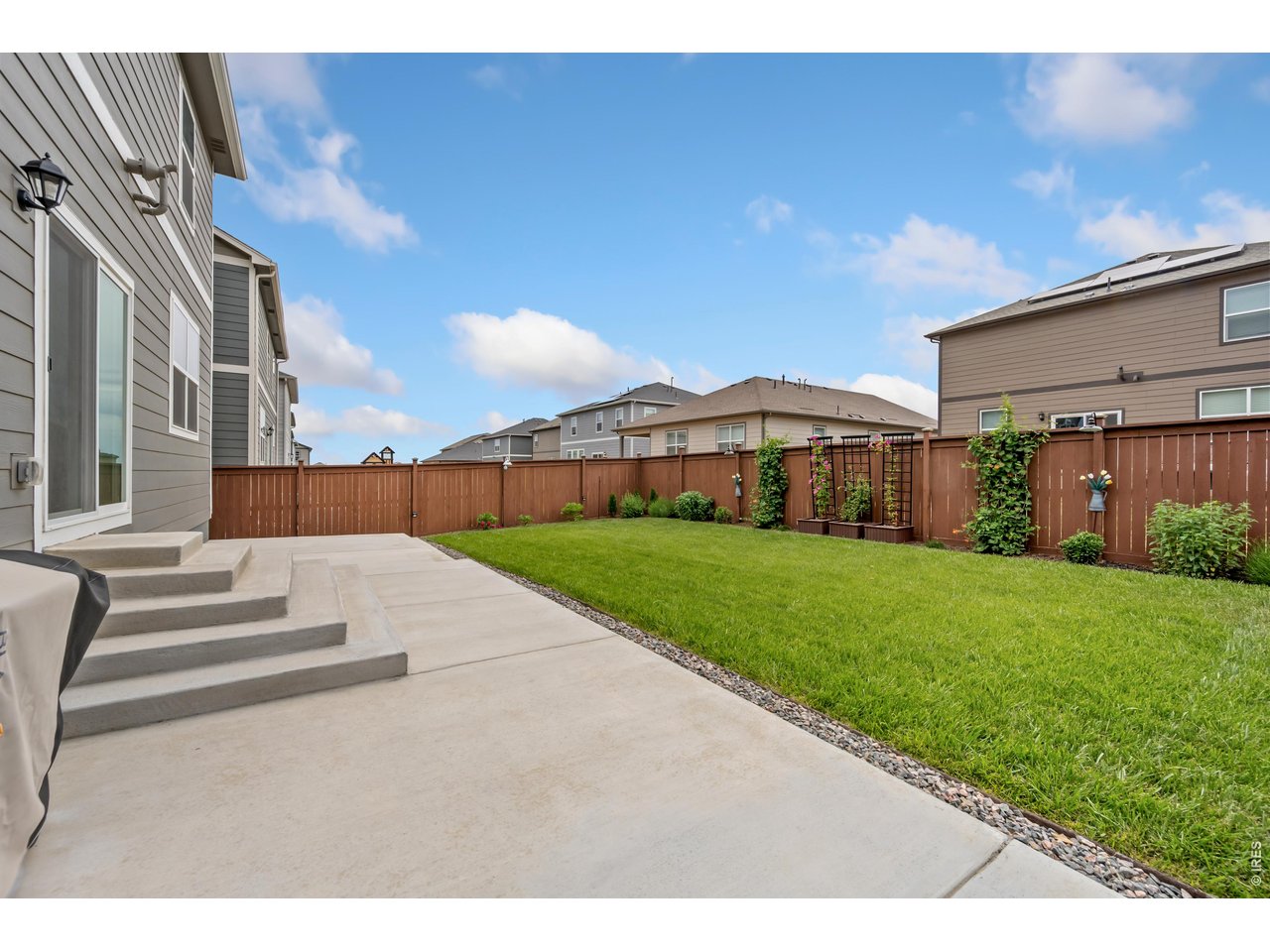352 Bluebird Road Johnstown, CO 80534 - Photo 23 of 26 Fully fenced back yard with extensive patio