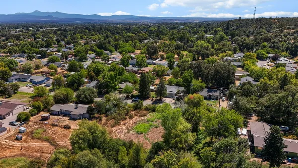 an aerial view of a residential houses and city view