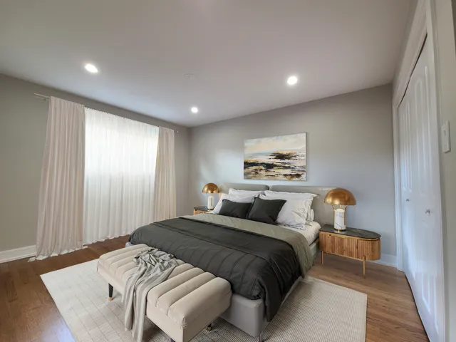 a bedroom with a bed and a painting on the wall