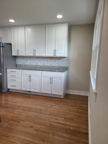 a view of a kitchen with wooden floor