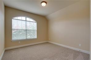 4679 Edith Street Plano, TX 75024 - Photo 27 of 34 Room featuring a large arched window with horizontal blinds, neutral carpet flooring, and a vaulted ceiling with a flush-mount light fixture
