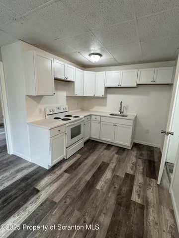 a kitchen with cabinets and white appliances