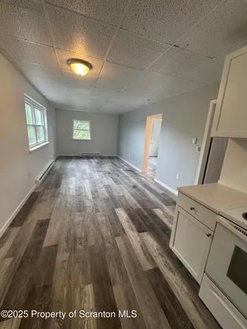 a view of a livingroom with wooden floor and window