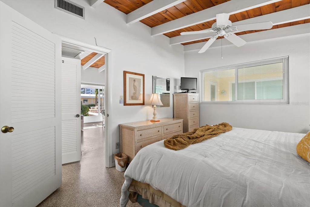 6006 Midnight Pass Road, Unit 11 Sarasota, FL 34242 - Photo 14 of 45 a bedroom with a bed and a cabinets