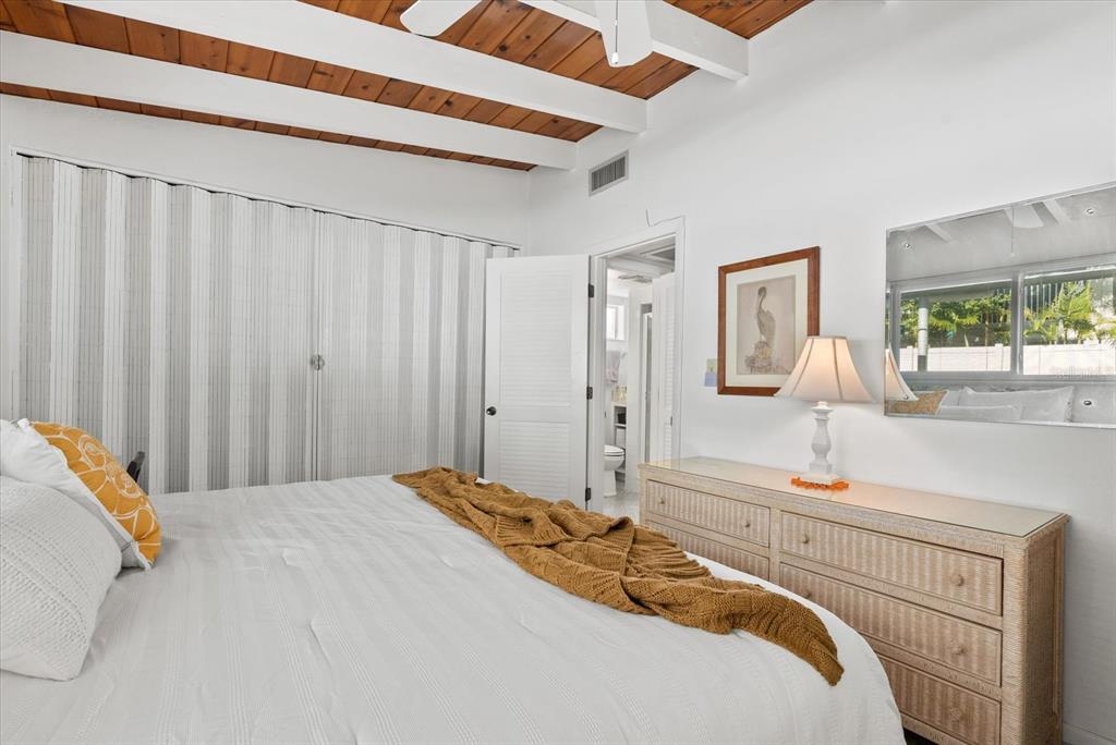 6006 Midnight Pass Road, Unit 11 Sarasota, FL 34242 - Photo 15 of 45 a bedroom with a bed and a window