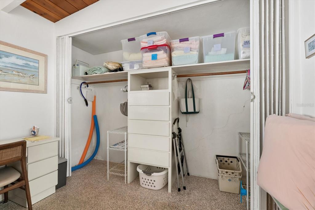 6006 Midnight Pass Road, Unit 11 Sarasota, FL 34242 - Photo 17 of 45 a view of walk in closet with clothes and shoes