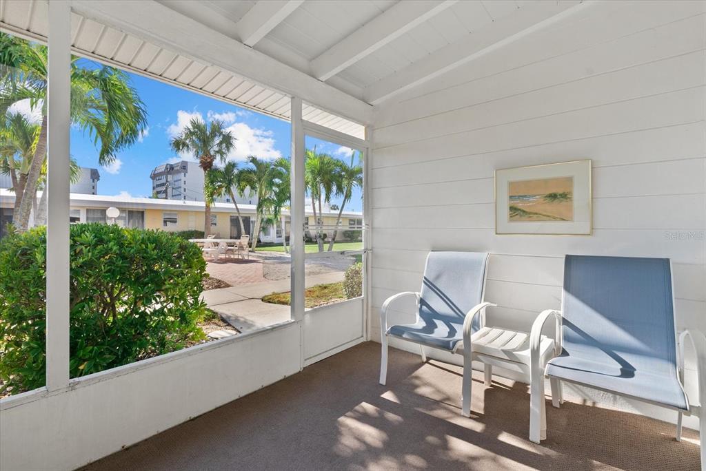 6006 Midnight Pass Road, Unit 11 Sarasota, FL 34242 - Photo 19 of 45 a outdoor living space with furniture and garden view