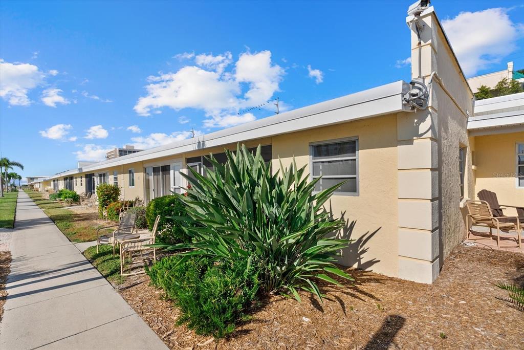 6006 Midnight Pass Road, Unit 11 Sarasota, FL 34242 - Photo 20 of 45 a front view of a house with garden