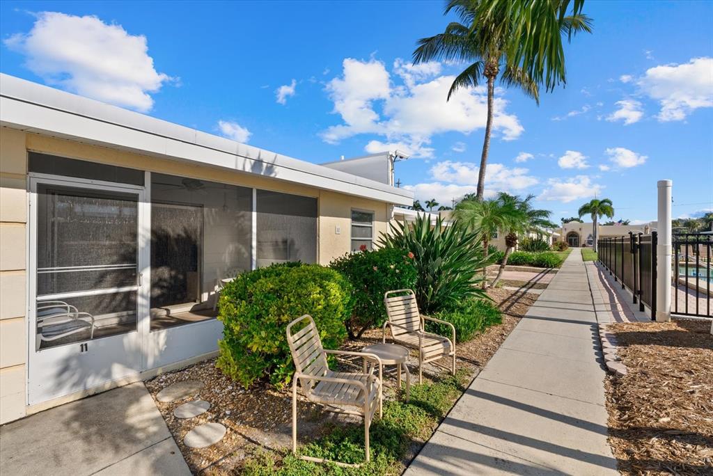 6006 Midnight Pass Road, Unit 11 Sarasota, FL 34242 - Photo 2 of 45 a view of a backyard with plants and a patio