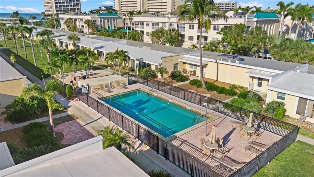 6006 Midnight Pass Road, Unit 11 Sarasota, FL 34242 - Photo 24 of 45 a view of a patio with a table and chairs