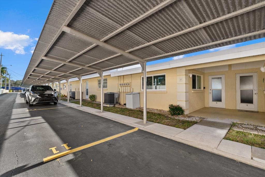 6006 Midnight Pass Road, Unit 11 Sarasota, FL 34242 - Photo 3 of 45 a view of a car park in front of house