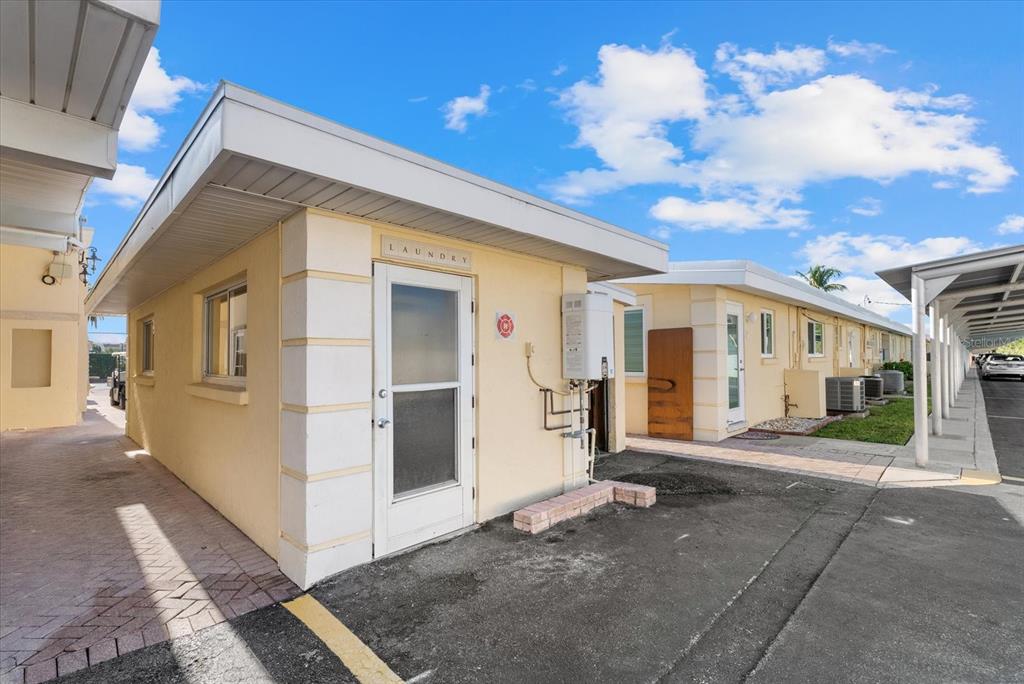 6006 Midnight Pass Road, Unit 11 Sarasota, FL 34242 - Photo 32 of 45 a view of a white house with a large space