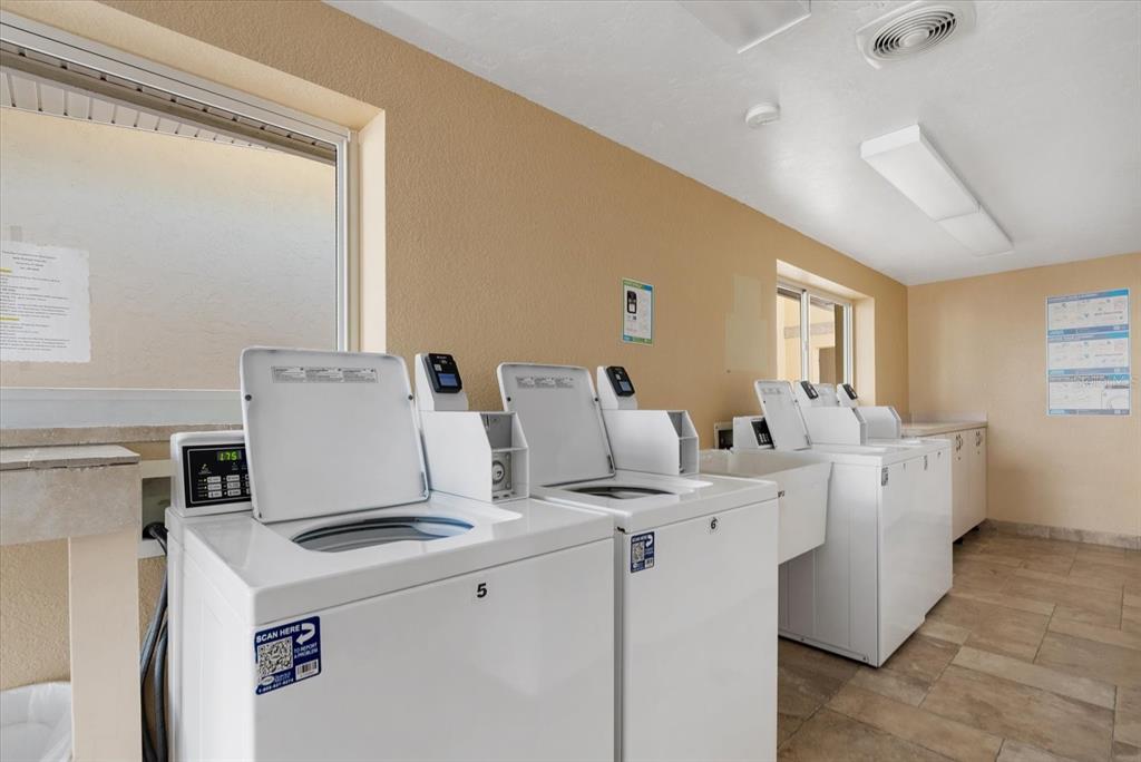 6006 Midnight Pass Road, Unit 11 Sarasota, FL 34242 - Photo 34 of 45 a utility room with dryer and washer