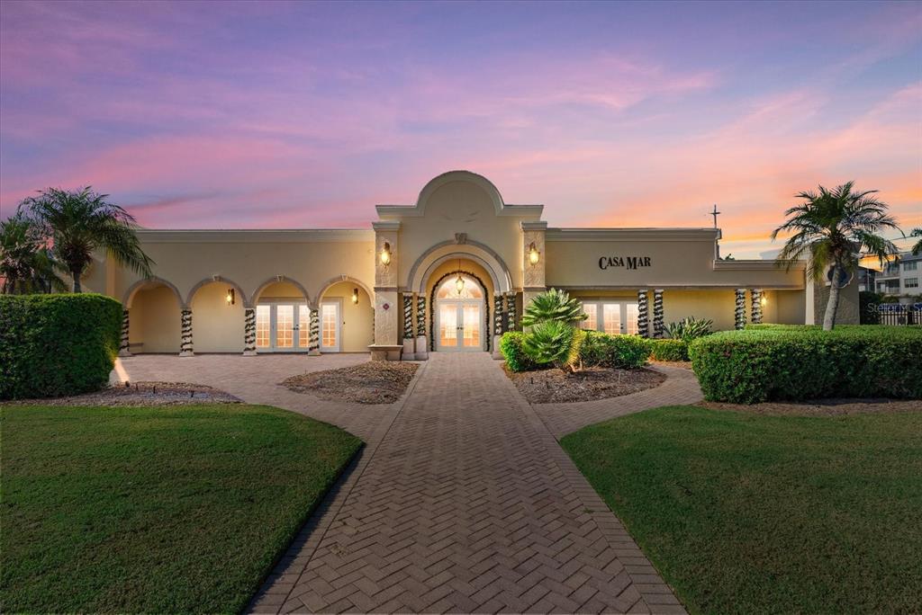 6006 Midnight Pass Road, Unit 11 Sarasota, FL 34242 - Photo 44 of 45 a front view of a house with a garden and plants