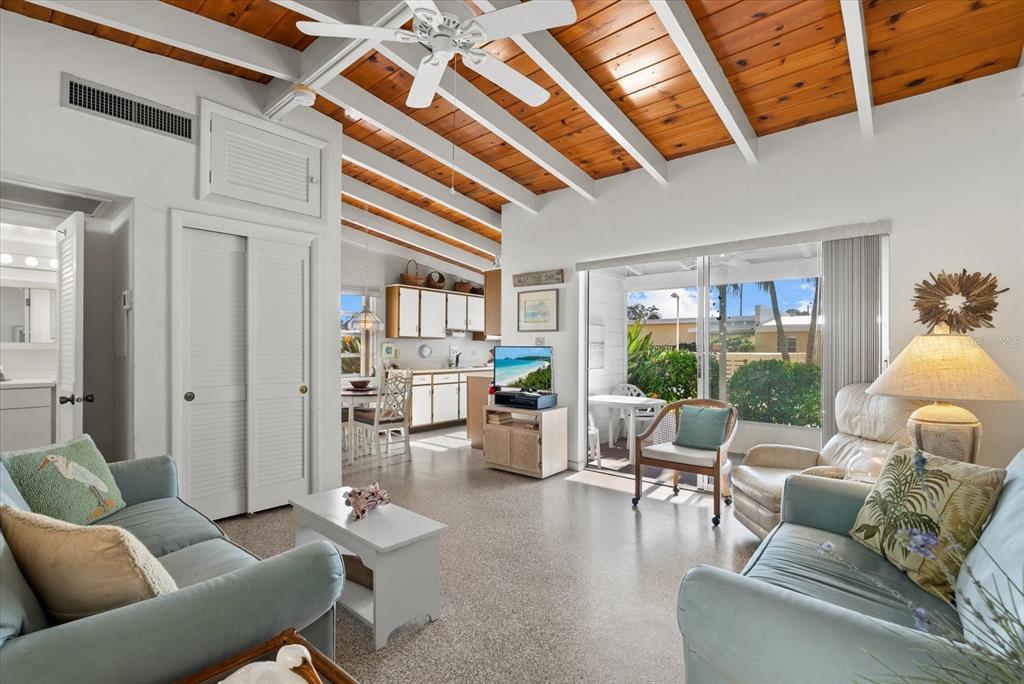 6006 Midnight Pass Road, Unit 11 Sarasota, FL 34242 - Photo 5 of 45 a living room with furniture and wooden floor