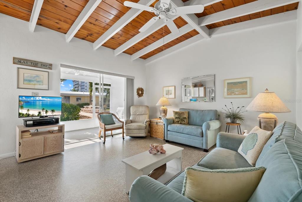 6006 Midnight Pass Road, Unit 11 Sarasota, FL 34242 - Photo 6 of 45 a living room with furniture and a wooden floor