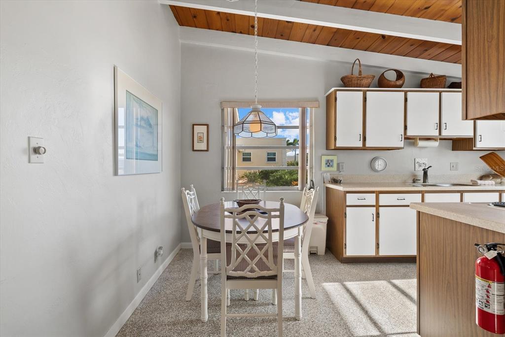 6006 Midnight Pass Road, Unit 11 Sarasota, FL 34242 - Photo 8 of 45 a kitchen with a sink cabinets and window