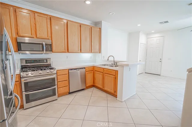 a kitchen with a stove a sink and a microwave