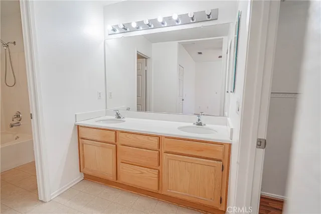 a bathroom with a double vanity sink and a mirror