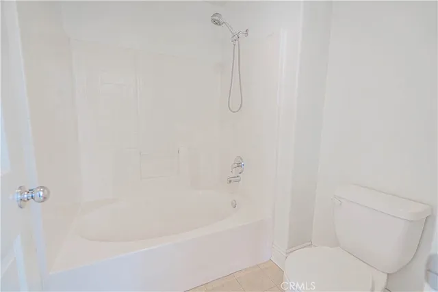 a white bath tub sitting next to a toilet