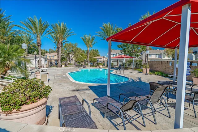 a patio with a table and chairs under an umbrella