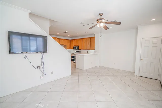 a view of kitchen with furniture and ceiling fan