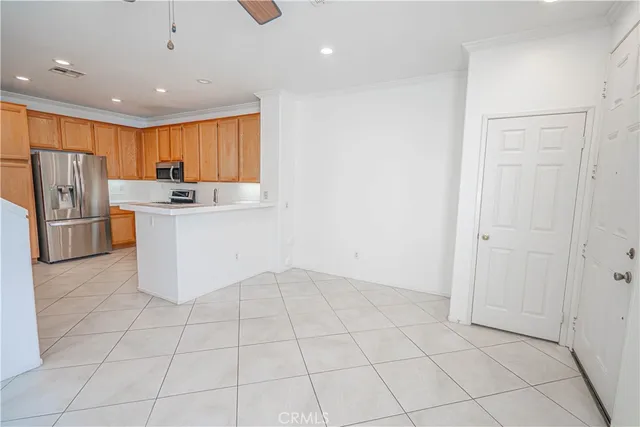a kitchen with stainless steel appliances a refrigerator sink and cabinets