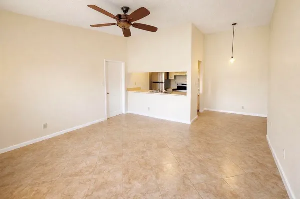 a view of a kitchen with a sink and a refrigerator