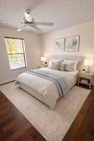 a bedroom with a large bed and a window