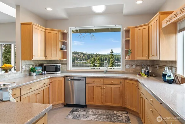 a dining room with furniture and large windows
