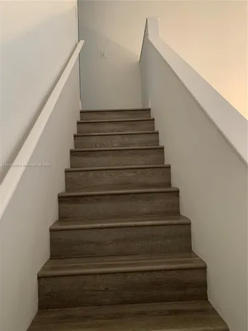 a view of a room with a chandelier fan and windows