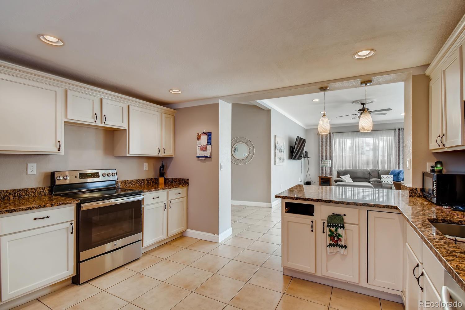 816 3rd Street Fort Lupton, CO 80621 - Photo 11 of 31 a kitchen with granite countertop cabinets stainless steel appliances and a counter space