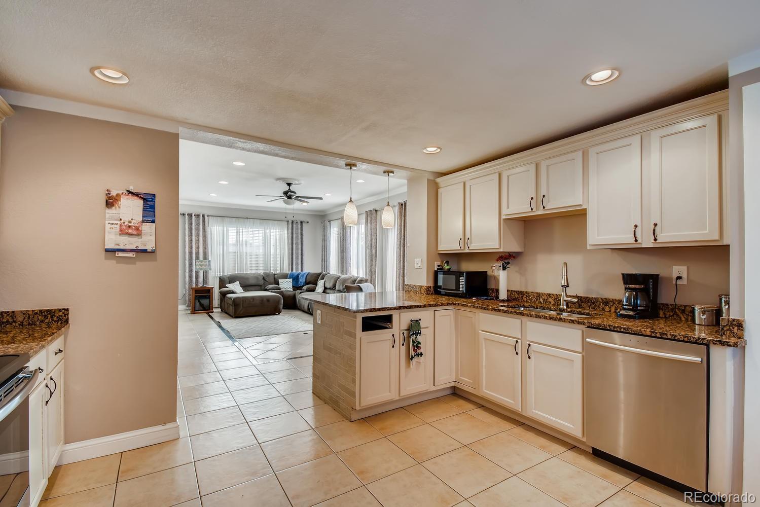 816 3rd Street Fort Lupton, CO 80621 - Photo 12 of 31 a kitchen with cabinets a sink and appliances