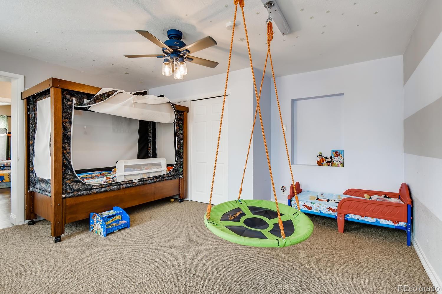 816 3rd Street Fort Lupton, CO 80621 - Photo 24 of 31 a room with furniture and a flat screen tv