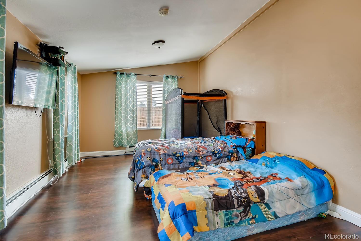 816 3rd Street Fort Lupton, CO 80621 - Photo 26 of 31 a bedroom with bed and a window