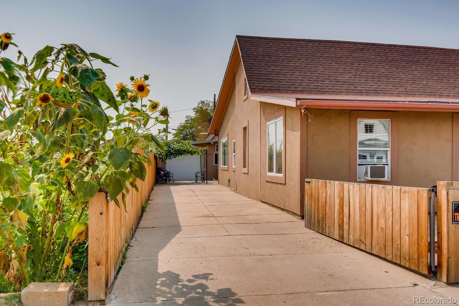 816 3rd Street Fort Lupton, CO 80621 - Photo 3 of 31 a balcony with potted plants in front of it
