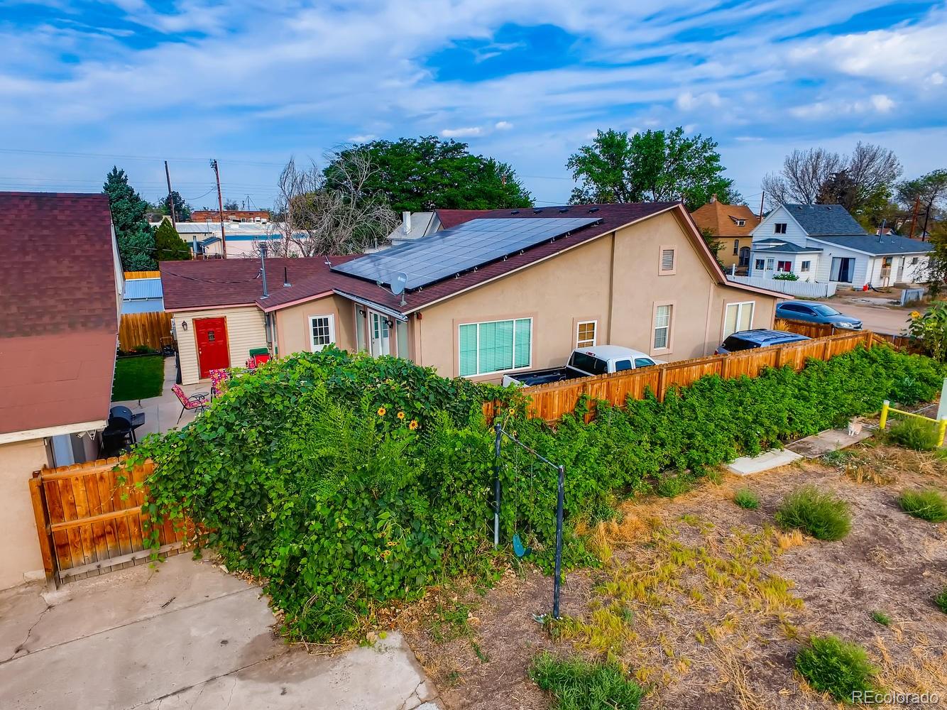 816 3rd Street Fort Lupton, CO 80621 - Photo 4 of 31 an aerial view of a house with a yard and potted plants
